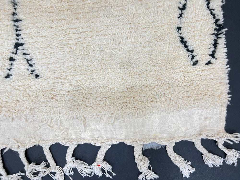 Handwoven white and black Moroccan wool runner rug with minimalist geometric lines, inspired by Beni Ourain design