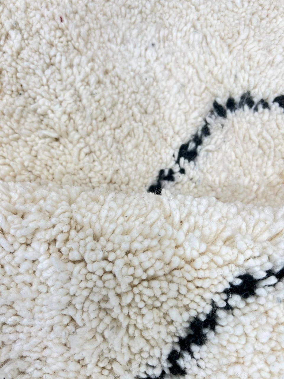Handwoven white and black Moroccan wool runner rug with minimalist geometric lines, inspired by Beni Ourain design