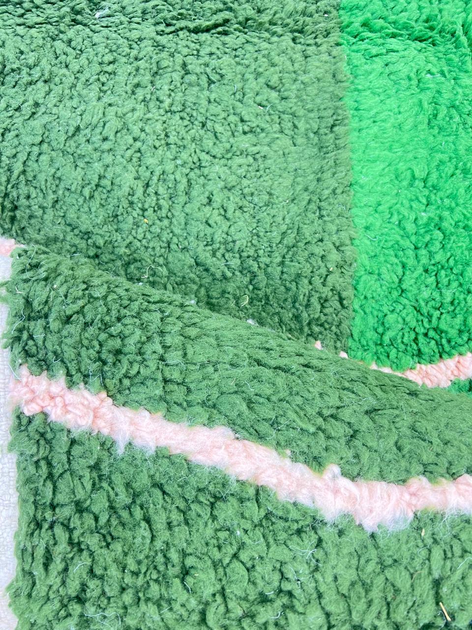 Round handmade Moroccan wool rug in green with ivory Berber pattern