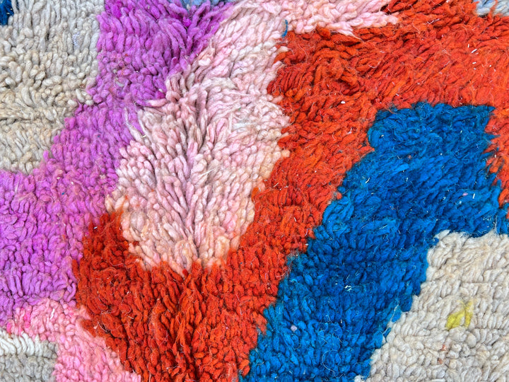 Round colorful Moroccan wool rug with abstract Berber pattern handmade by artisans