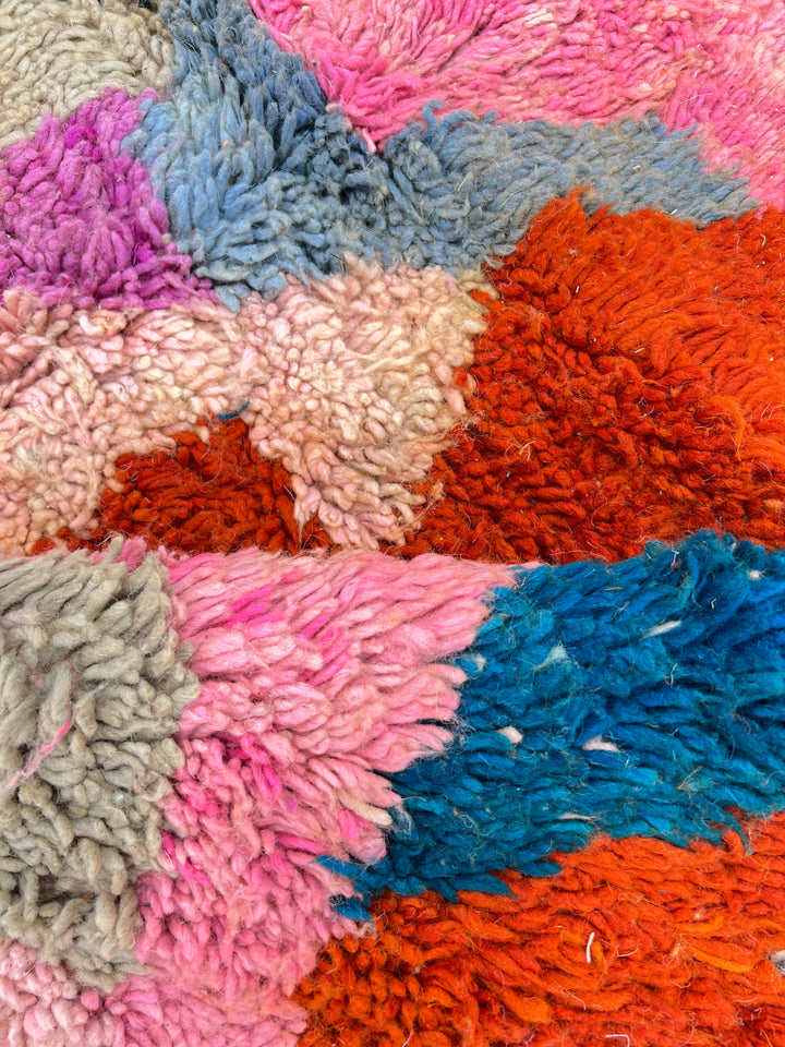 Round colorful Moroccan wool rug with abstract Berber pattern handmade by artisans