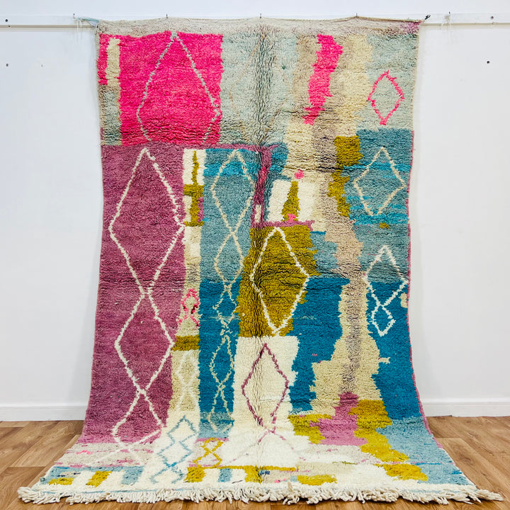 Vintage Moroccan Berber rug with pink and blue abstract diamond patterns, handwoven, 8.5x5.3 ft, 100% natural wool.
