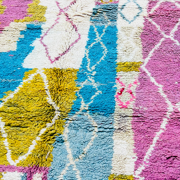 Vintage Moroccan Berber rug with abstract pink, blue, mustard, and ivory diamond patterns in wool. Handwoven, 8.5x5.3 ft.