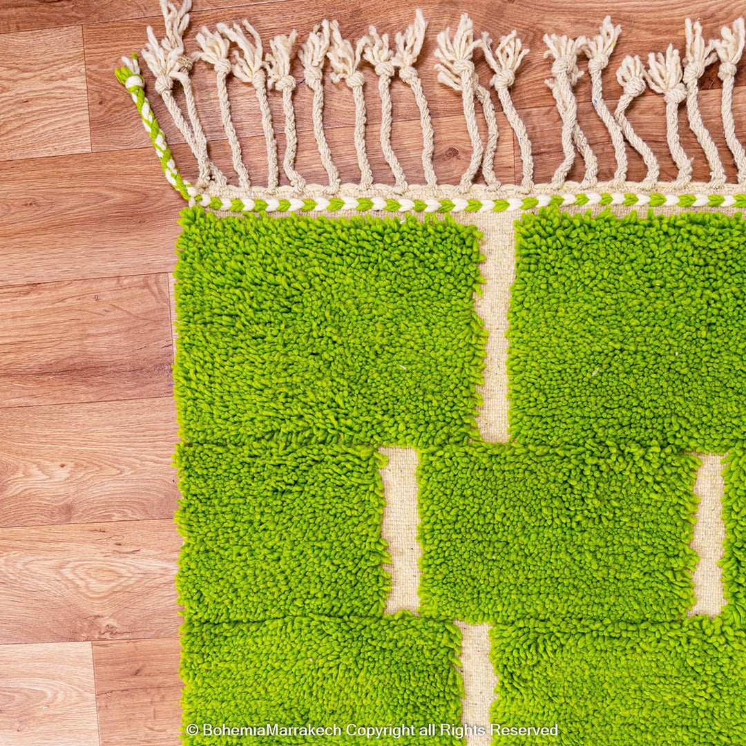 Handmade Moroccan rug in green checkered brick design, crafted from soft wool by Berber artisans