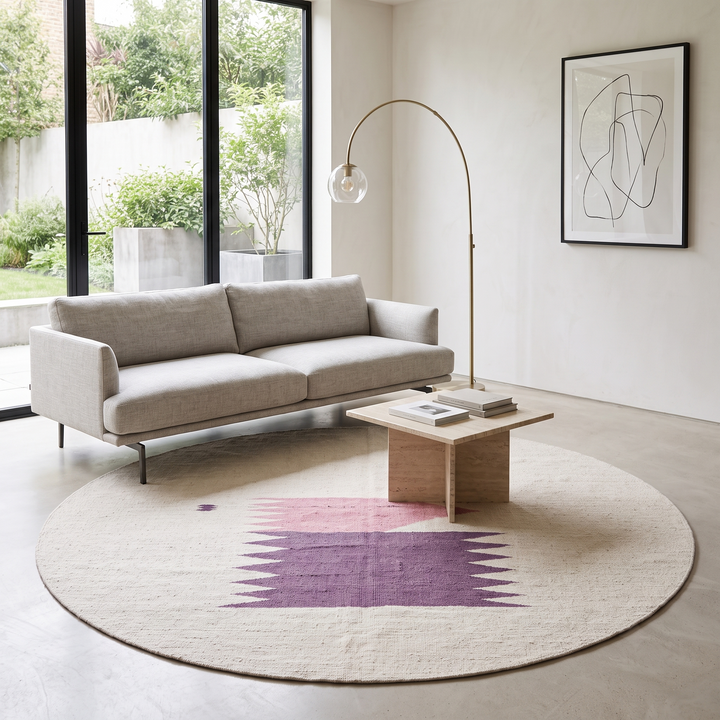 Flat weave round Moroccan wool rug with minimalist abstract pink and purple design on white background