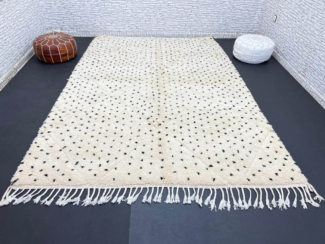 Handwoven Moroccan wool rug with small black dotted patterns on an ivory background, minimalist Beni Ourain design