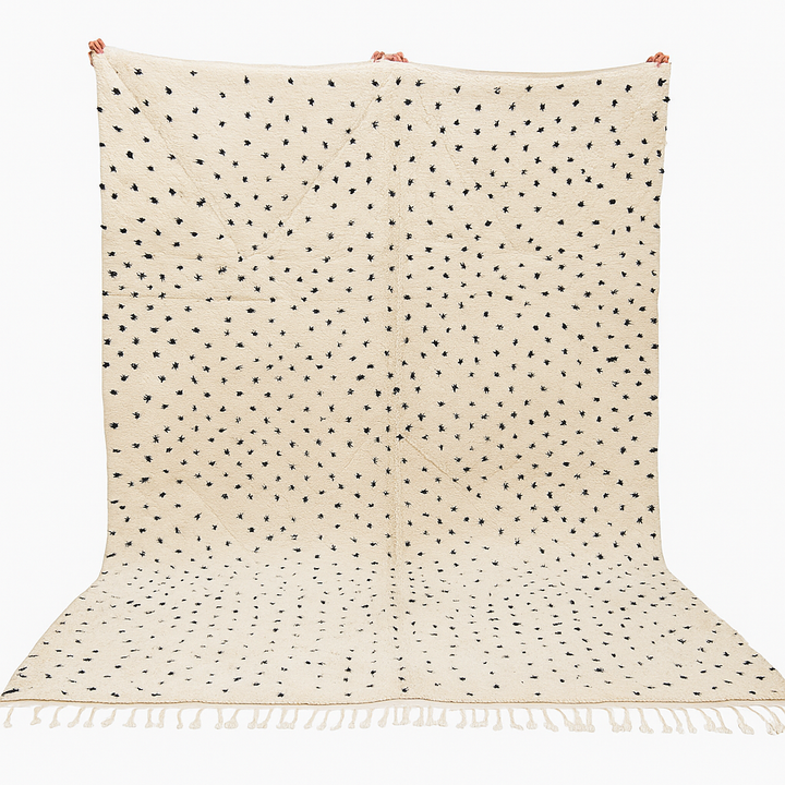 Handwoven Moroccan wool rug with small black dotted patterns on an ivory background, minimalist Beni Ourain design