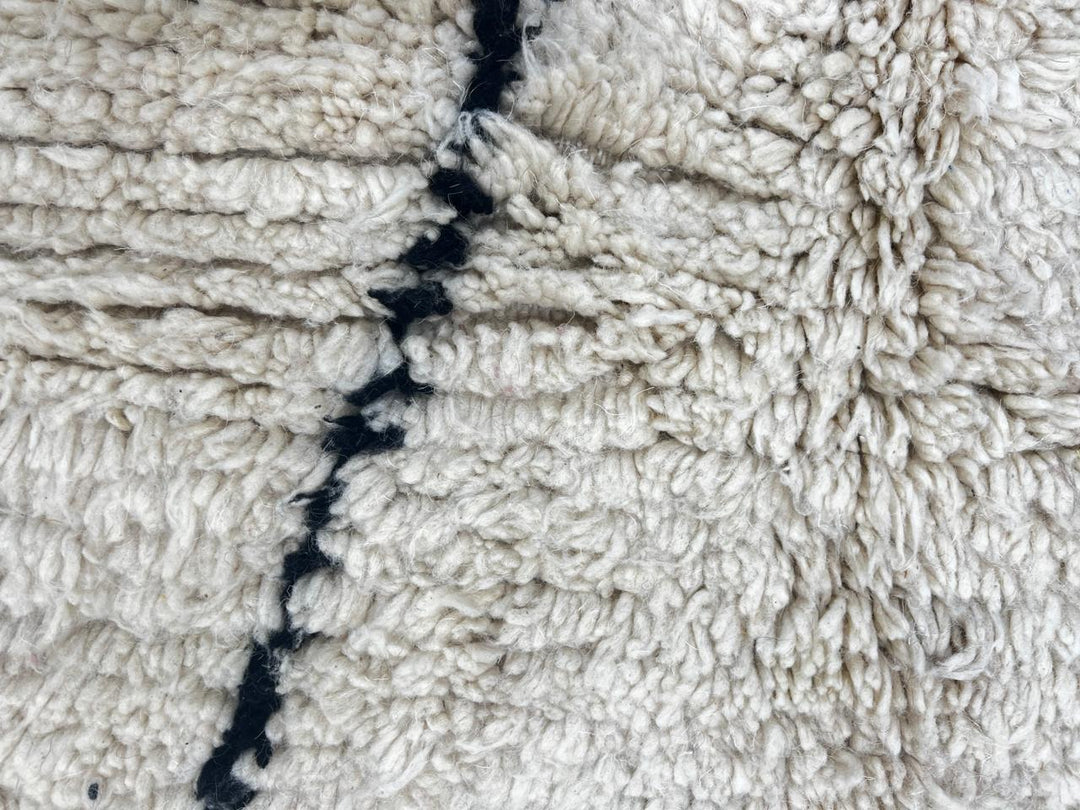 Handmade white Moroccan runner rug with minimalist black geometric line pattern in soft natural wool.
