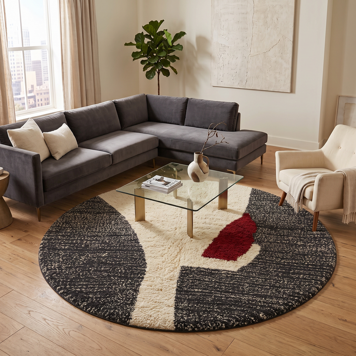Round modern Moroccan rug with abstract black, white, and red textured pattern.