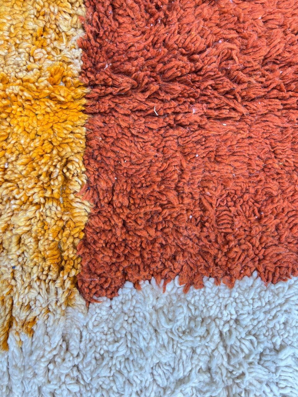 Handmade Moroccan wool rug with modern abstract geometric design in navy, teal, pink, orange, and mustard tones