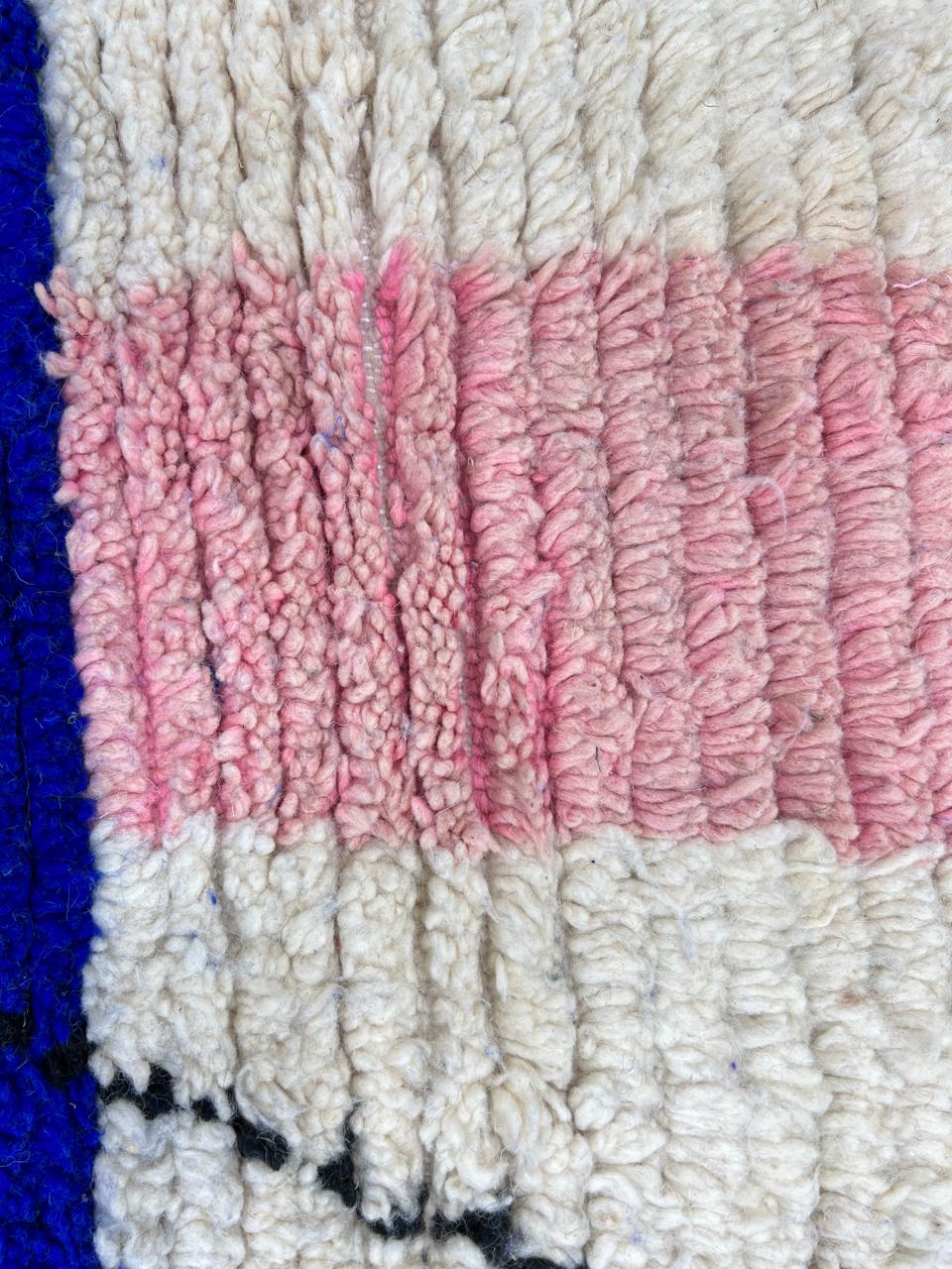 Handmade modern Moroccan wool rug with blue, pink, ivory, and black geometric abstract design