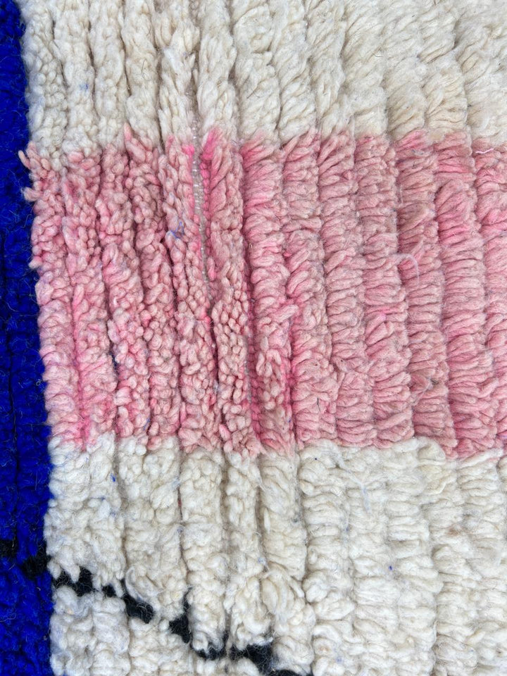Handmade modern Moroccan wool rug with blue, pink, ivory, and black geometric abstract design