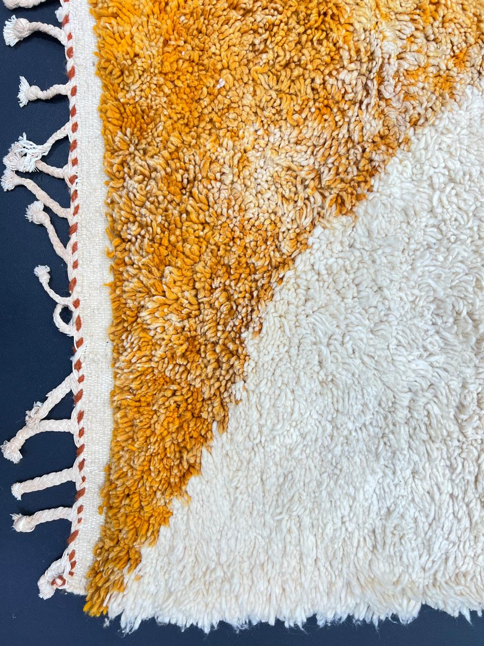 Handmade Moroccan runner rug with colorful abstract geometric shapes in blue, pink, and orange on a white wool background.