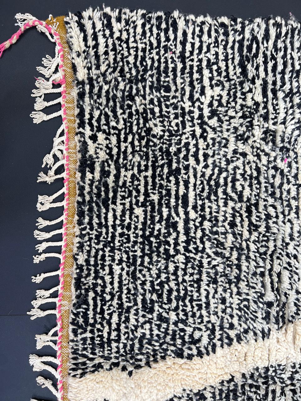 Handwoven Moroccan wool rug with abstract modern pattern in ivory, black, and red tones
