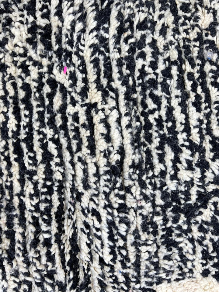 Handwoven Moroccan wool rug with abstract modern pattern in ivory, black, and red tones
