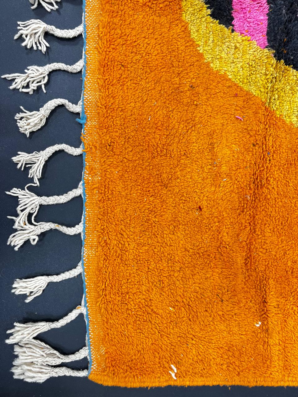 Handmade Moroccan wool runner rug with bold abstract geometric motif on an orange background