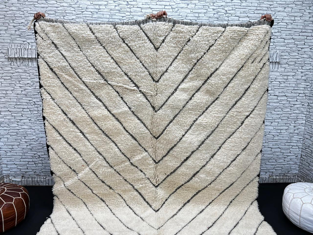 Modern Moroccan Beni Ourain wool rug with black chevron lines on cream background, handmade by Berber artisans