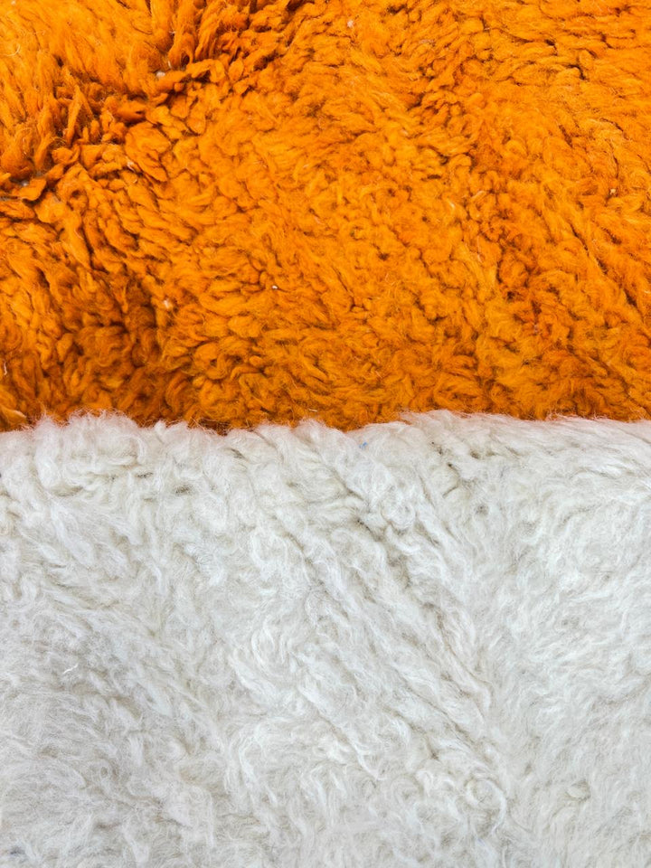 Handmade modern Moroccan wool runner rug with abstract red, orange, and yellow geometric design on a cream background
