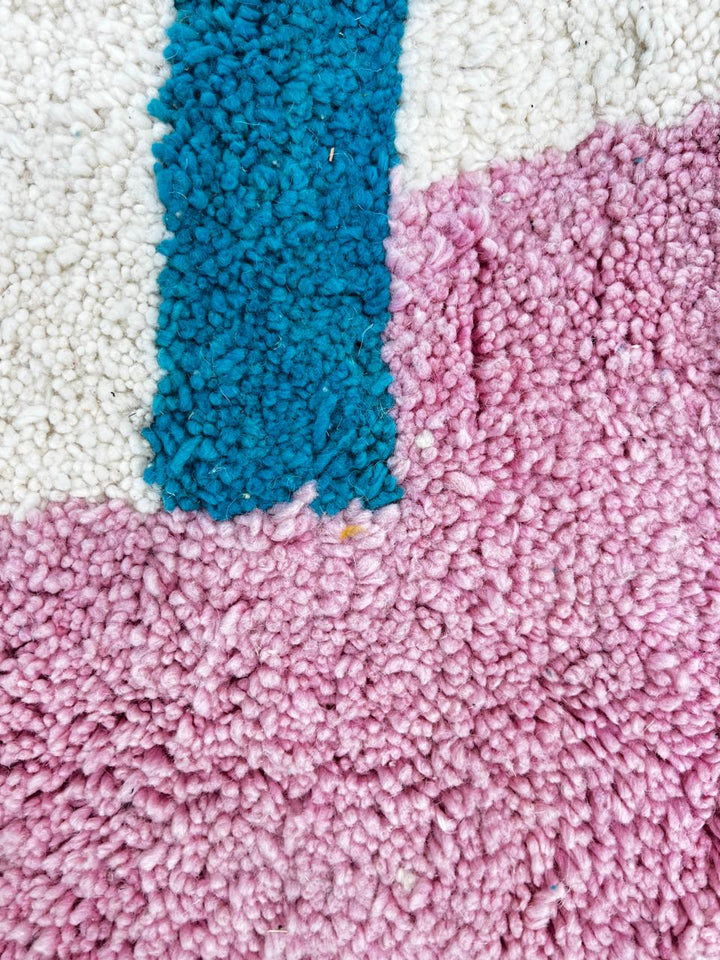 Handmade modern Moroccan runner rug with abstract orange, pink, and black geometric shapes on a white wool base