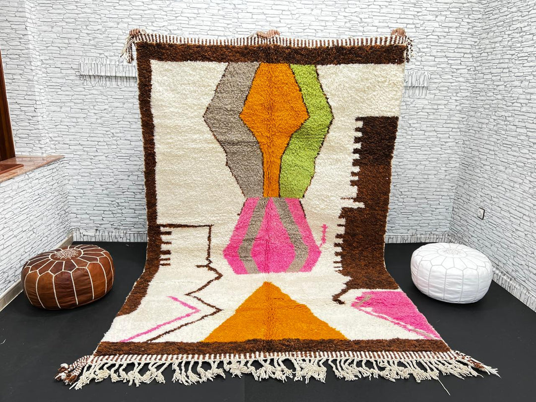 Modern Moroccan wool rug with abstract brown, orange, green, and pink geometric patterns, handmade by Berber artisans
