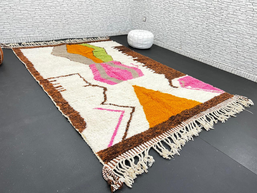 Modern Moroccan wool rug with abstract brown, orange, green, and pink geometric patterns, handmade by Berber artisans