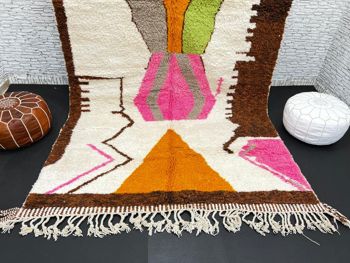 Modern Moroccan wool rug with abstract brown, orange, green, and pink geometric patterns, handmade by Berber artisans