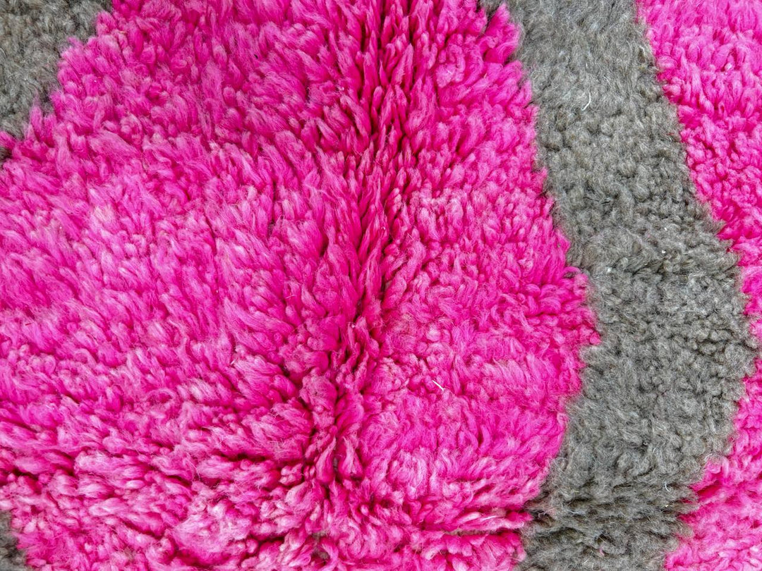 Modern Moroccan wool rug with abstract brown, orange, green, and pink geometric patterns, handmade by Berber artisans