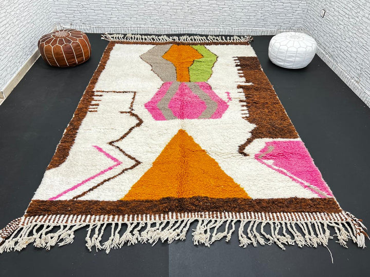 Modern Moroccan wool rug with abstract brown, orange, green, and pink geometric patterns, handmade by Berber artisans