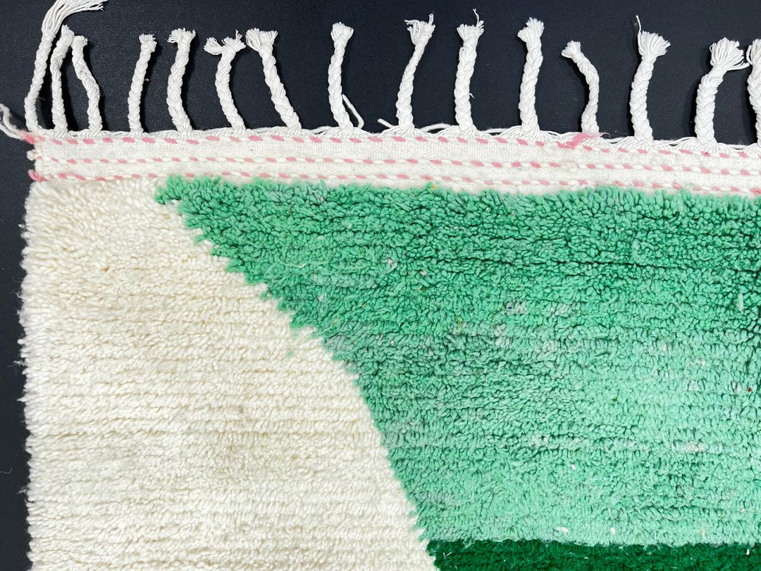 Modern Moroccan wool rug with pink and green hourglass geometric design, handmade by Berber artisans