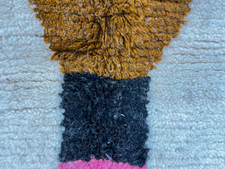 Modern Moroccan wool rug with pink and green hourglass geometric design, handmade by Berber artisans