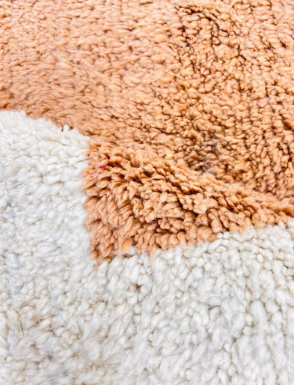 Round Moroccan wool rug with modern abstract Berber design in earth tones