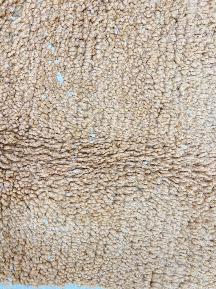 Handmade Moroccan runner rug with brown and white abstract desert-inspired design, crafted from natural wool by Berber artisans.