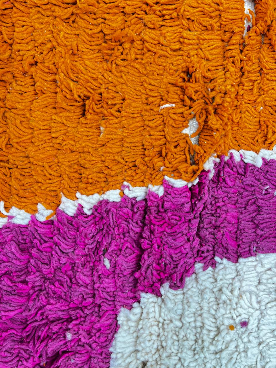 Handwoven multicolor Moroccan wool rug with orange, pink, green, and blue abstract geometric design