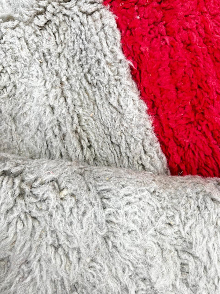 Handmade wool Moroccan runner rug with modern color-blocked design in orange, cream, grey, red, black, and yellow.