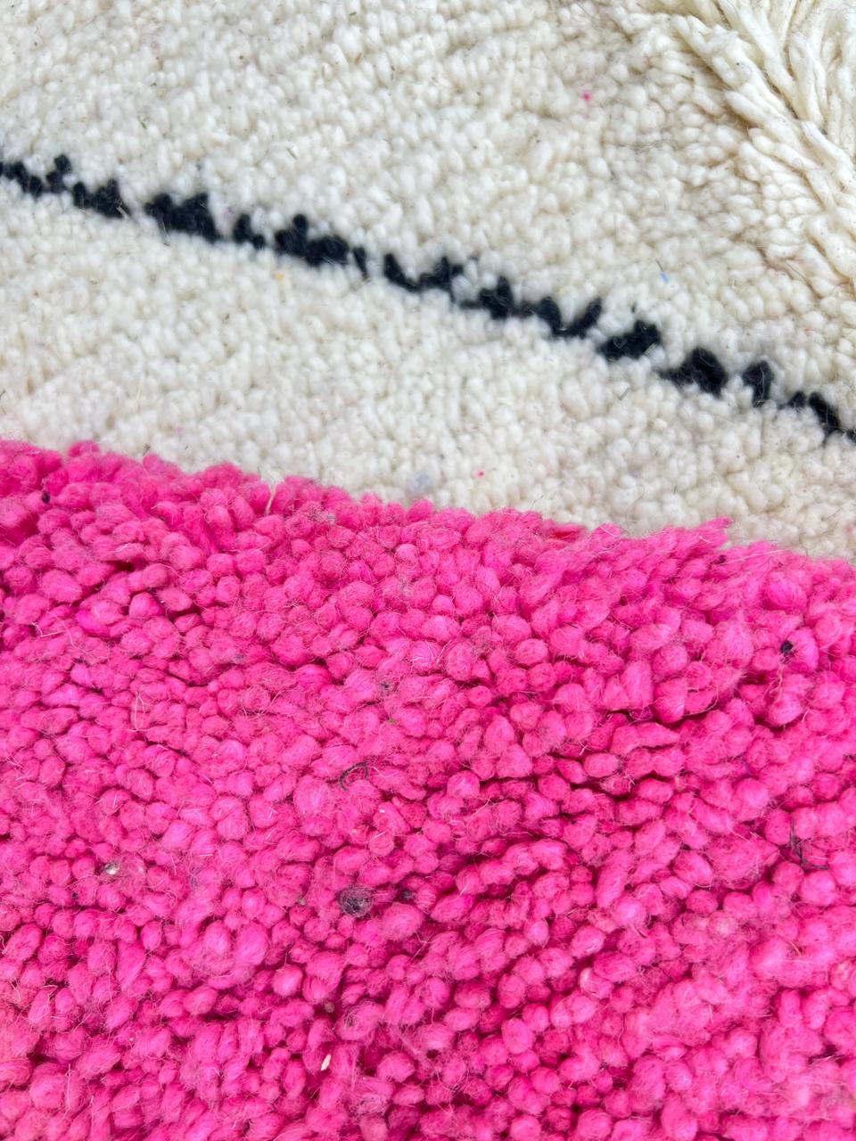 Handmade Moroccan wool rug in pink, black, and ivory with bold diamond geometric design
