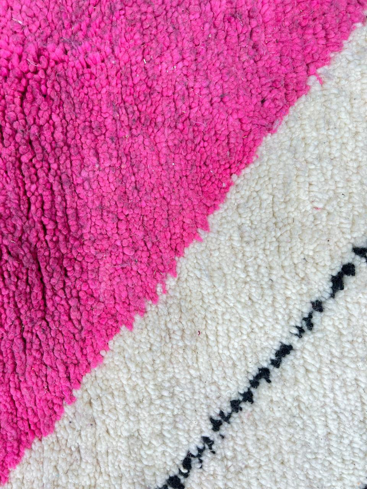 Handmade Moroccan wool rug in pink, black, and ivory with bold diamond geometric design