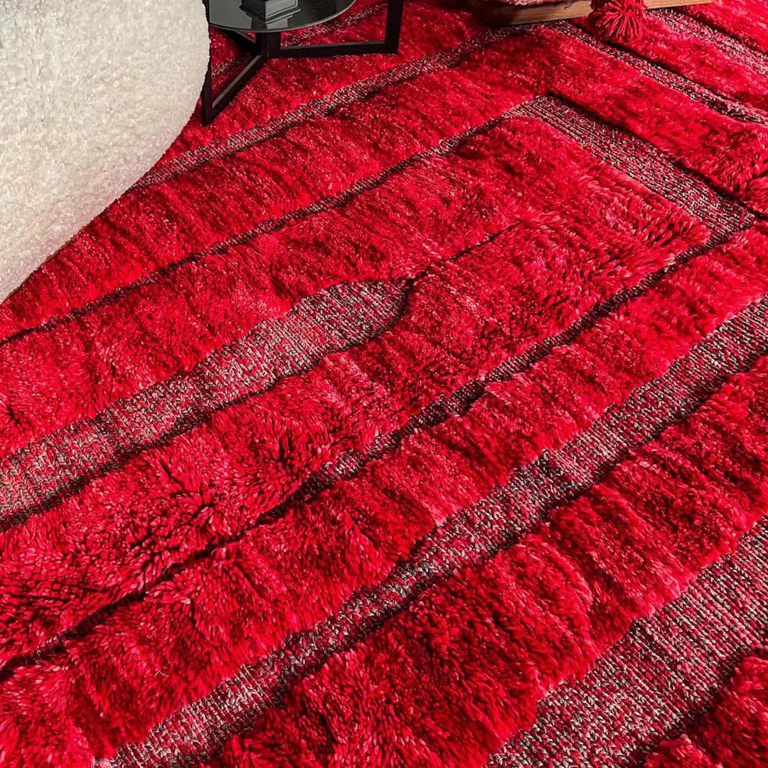 Handmade red Moroccan round rug with textured geometric lines and plush wool