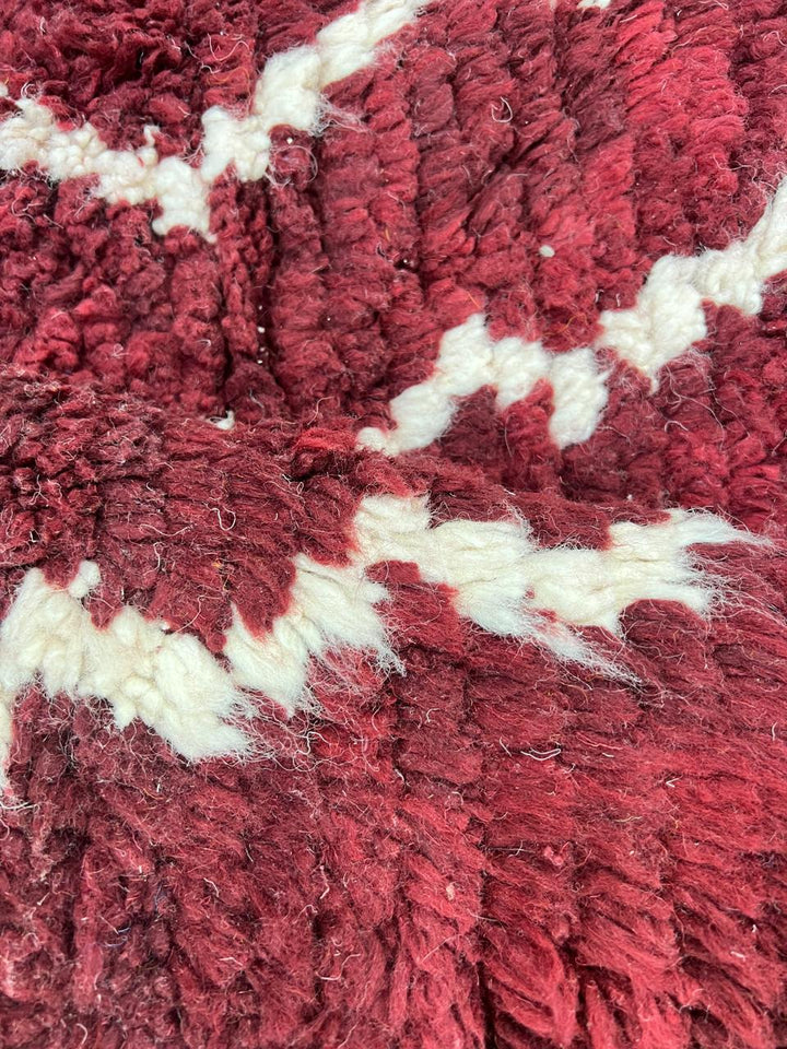 Handmade round Moroccan wool rug in rich burgundy red with ivory Berber geometric patterns, artisan-crafted Amazigh round area rug.