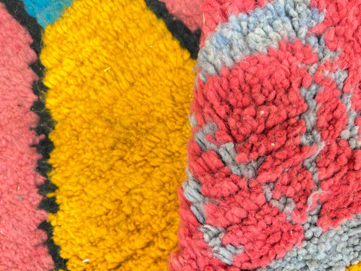 Round pink Moroccan rug with colorful geometric Berber motifs