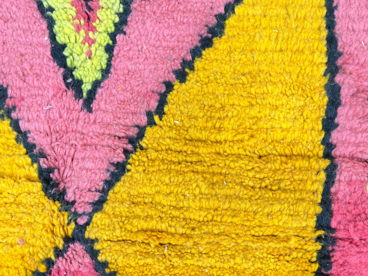 Round pink Moroccan rug with colorful geometric Berber motifs