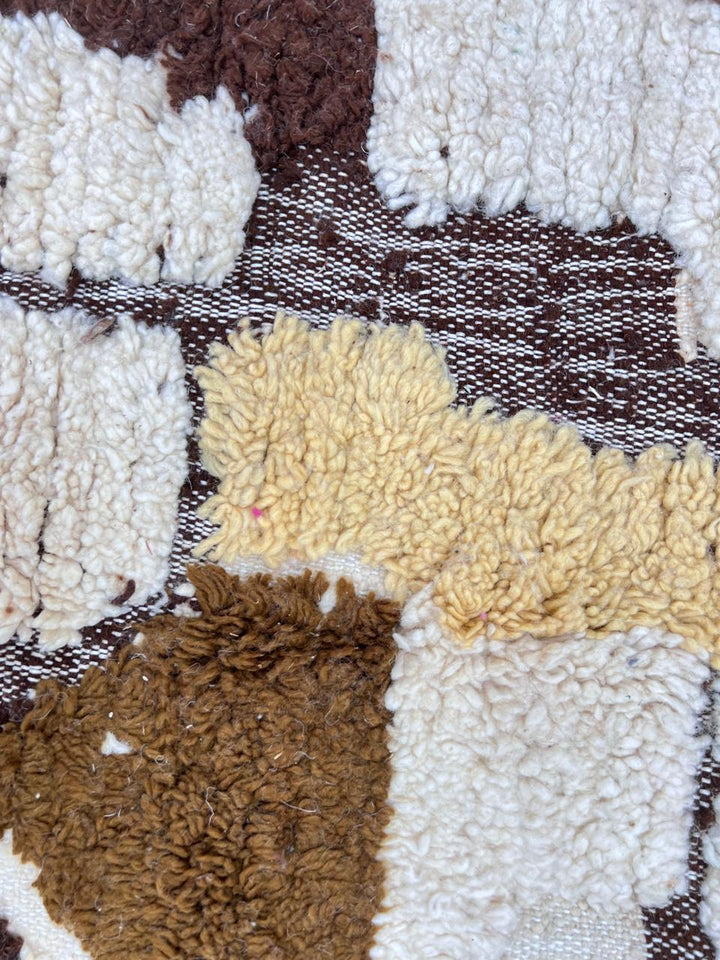 Round handmade Moroccan Berber rug in ivory and brown earth tones