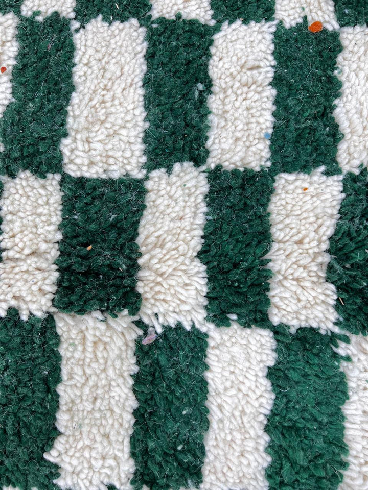 Round Moroccan wool rug with green and white checkerboard design, handmade checkered carpet