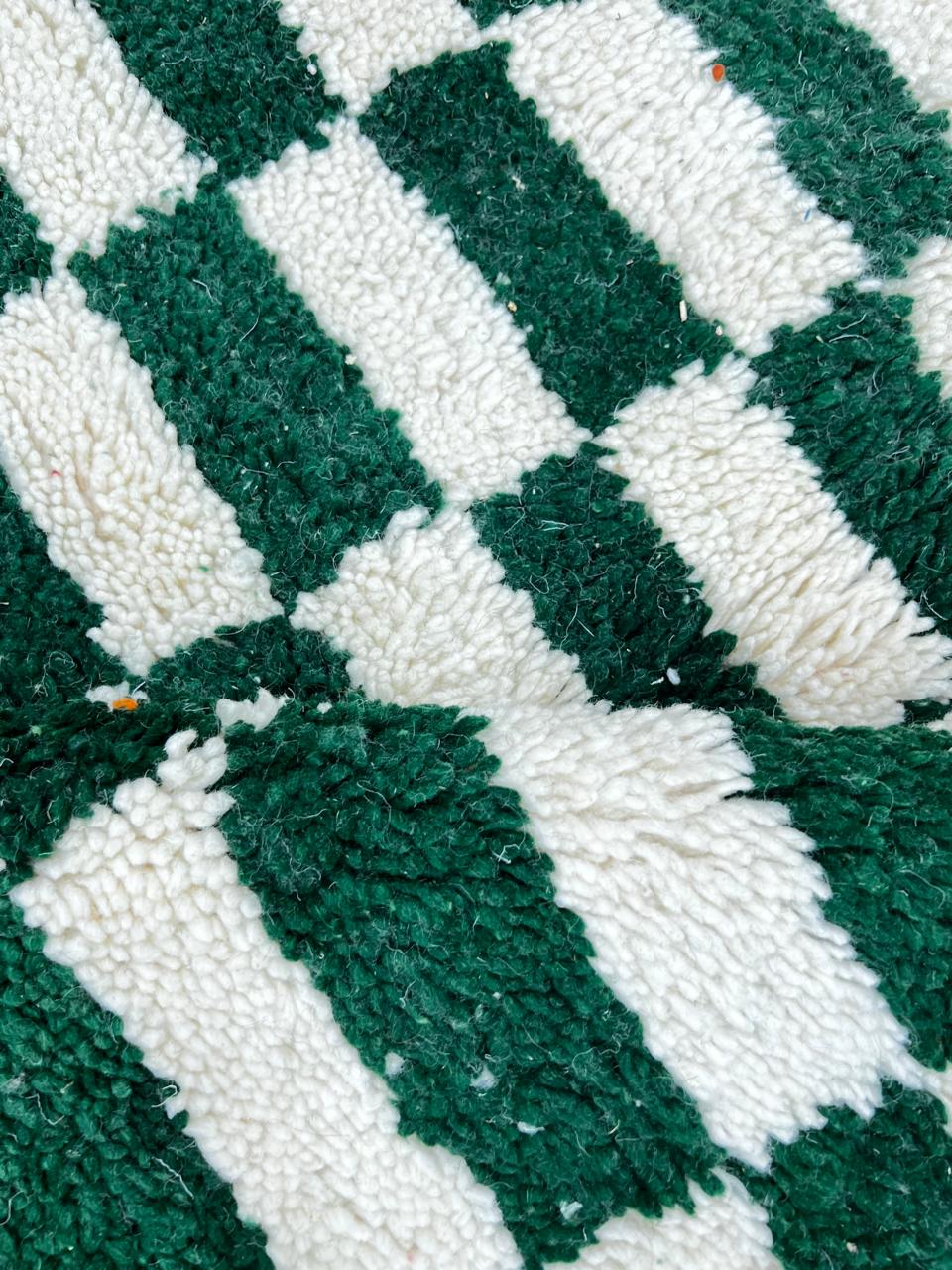 Round Moroccan wool rug with green and white checkerboard design, handmade checkered carpet
