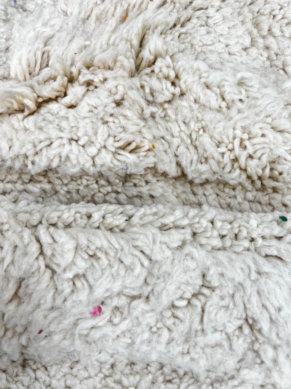 Round white Moroccan wool shag rug with minimalist solid design
