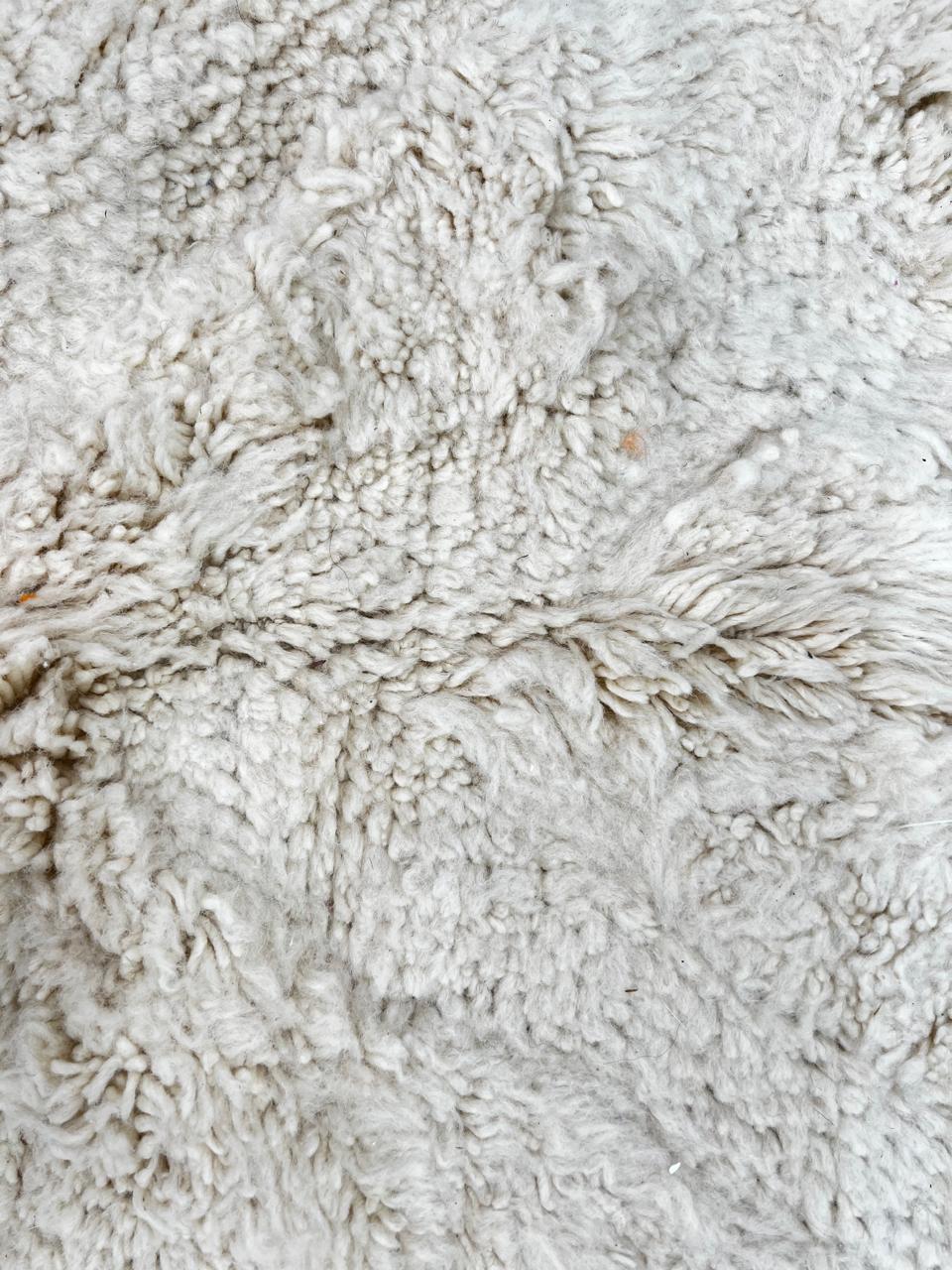 Round white Moroccan wool shag rug with minimalist solid design
