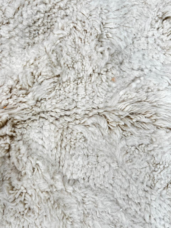 Round white Moroccan wool shag rug with minimalist solid design