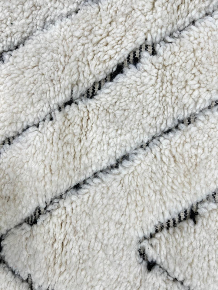 Round Beni Ourain Moroccan rug with white wool base and hand-drawn diamond pattern, handmade wool carpet