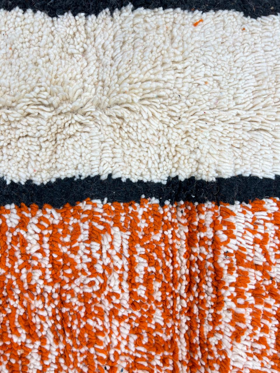 Round Moroccan rug with modern abstract geometric pattern in orange, white, black, teal, grey and rust tones, handmade wool design