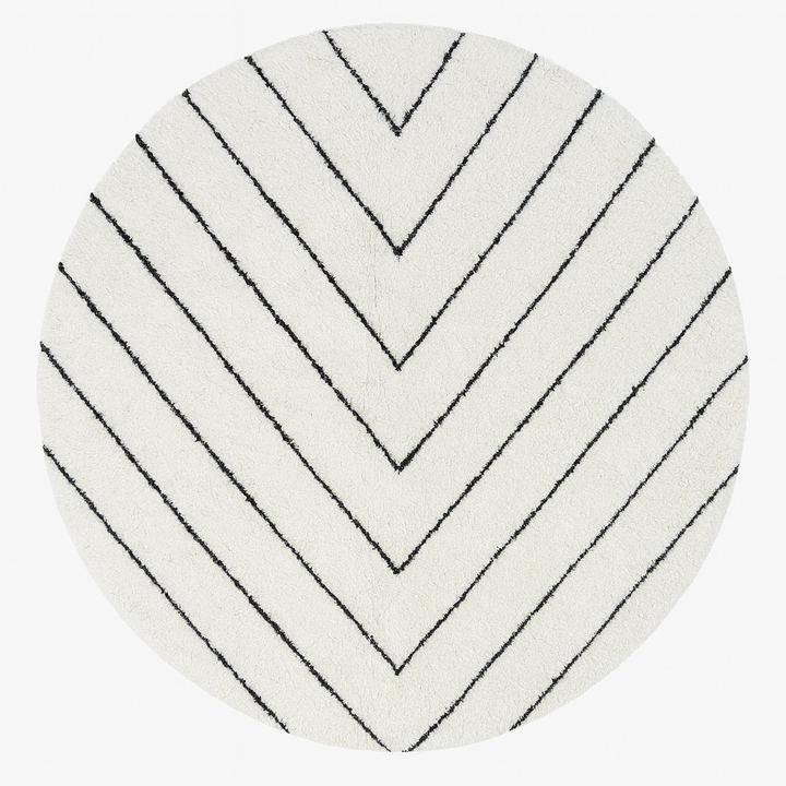 Round handmade Moroccan wool rug with modern carved line pattern, minimalist geometric design.