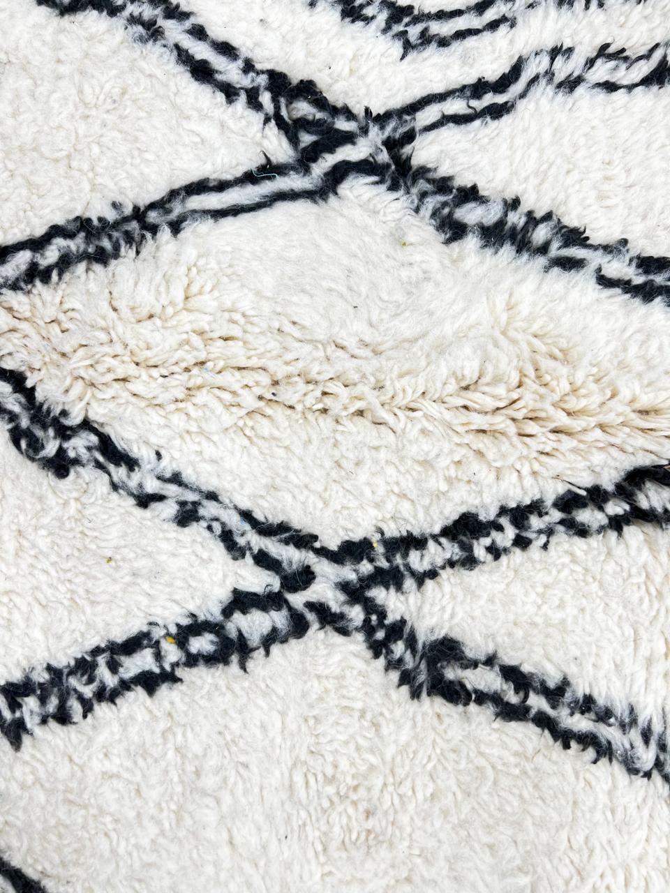 Round white Moroccan wool rug with black Beni Ourain diamond pattern